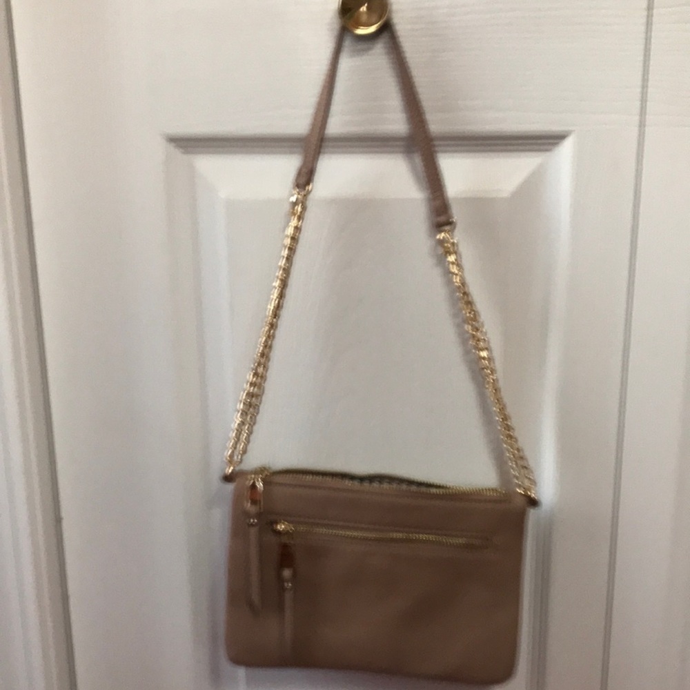 This a small tan shoulder bag